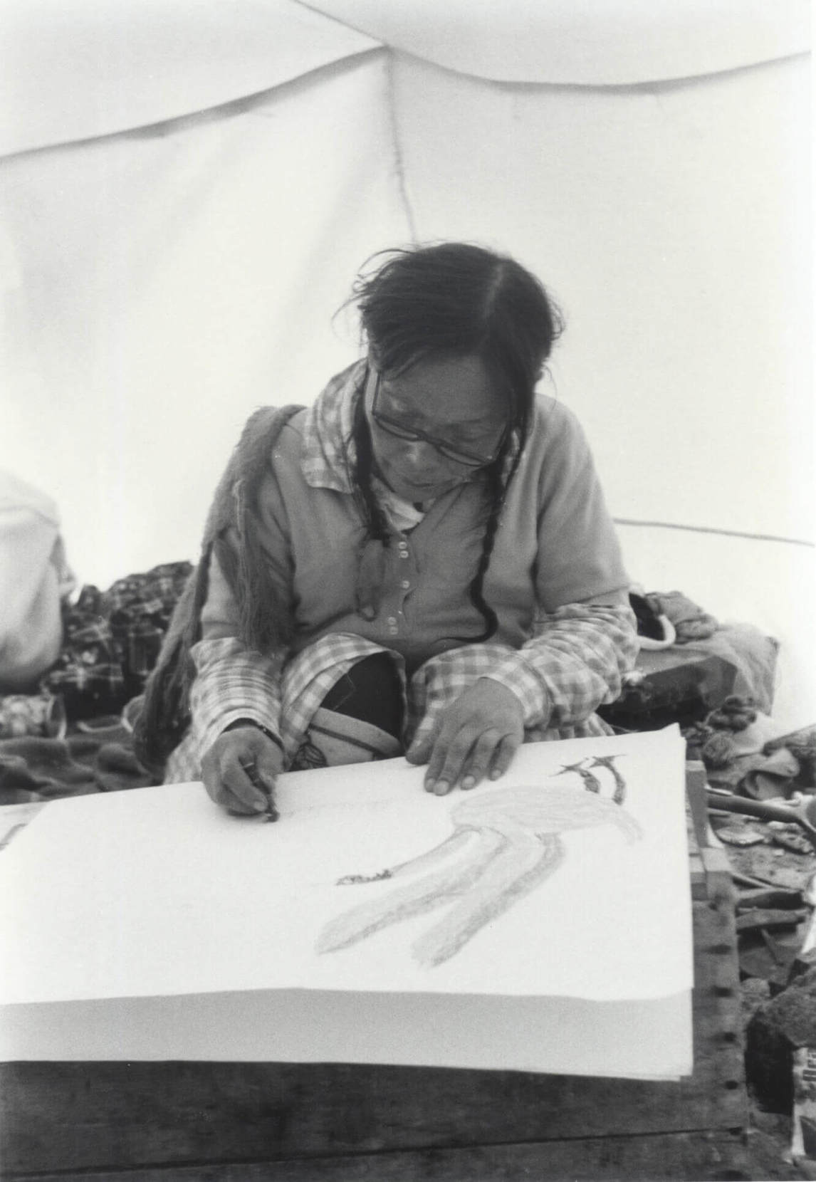 Art Canada Institute, Pitseolak drawing in her summer tent in Cape Dorset, June 1967