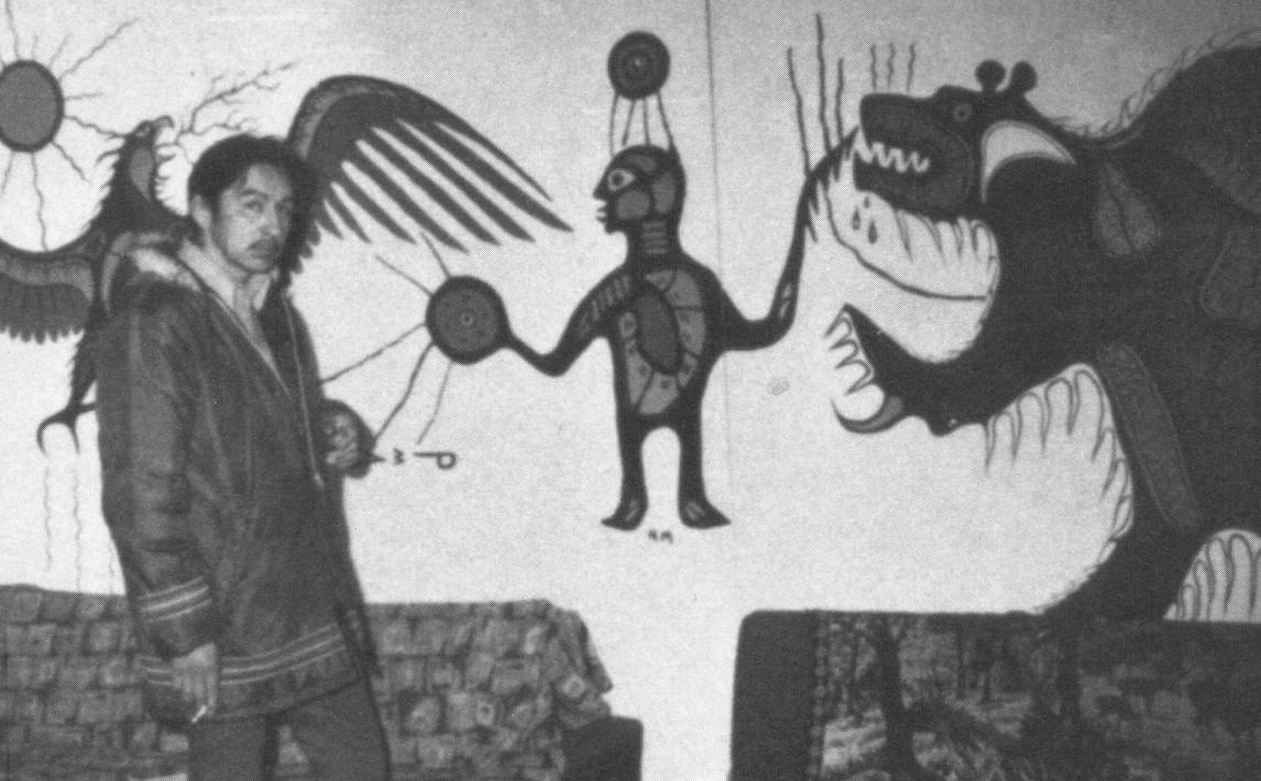 Art Canada Institute, Norval Morrisseau standing in front of a mural at the Red Lake Indian Friendship Centre, 1960s