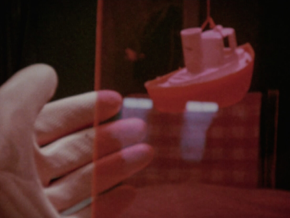 Art Canada Institute, Joyce Wieland, photograph of Wieland filming her self and objects in her kitchen for her film Water Sark