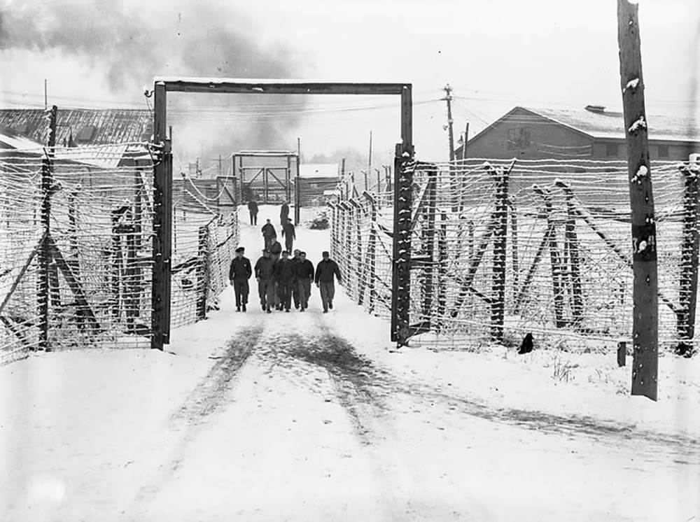 Art Canada Institute, Oscar Cahen, internees behind the barbed-wire fences at the Camp N internment camp in Sherbrooke, Quebec, on November 19, 1945