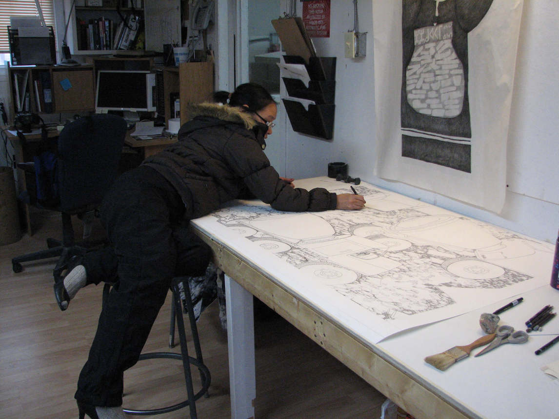 Art Canada Institute, Nancy Campbell, photograph of Shuvinai Ashoona drawing a landscape work at the Kinngait Studios, 2006