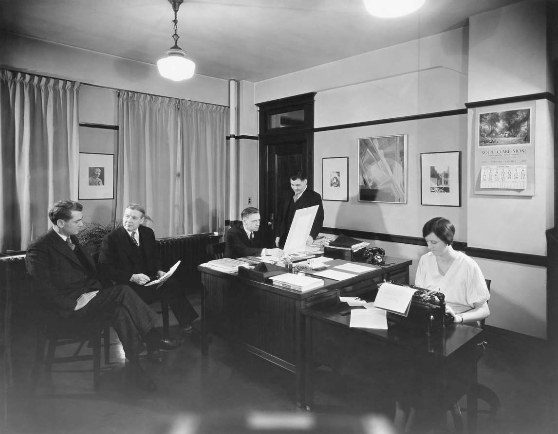Photograph of Bertram Brooker and colleagues in his office at J.J. Gibbons advertising agency in Toronto, 1934