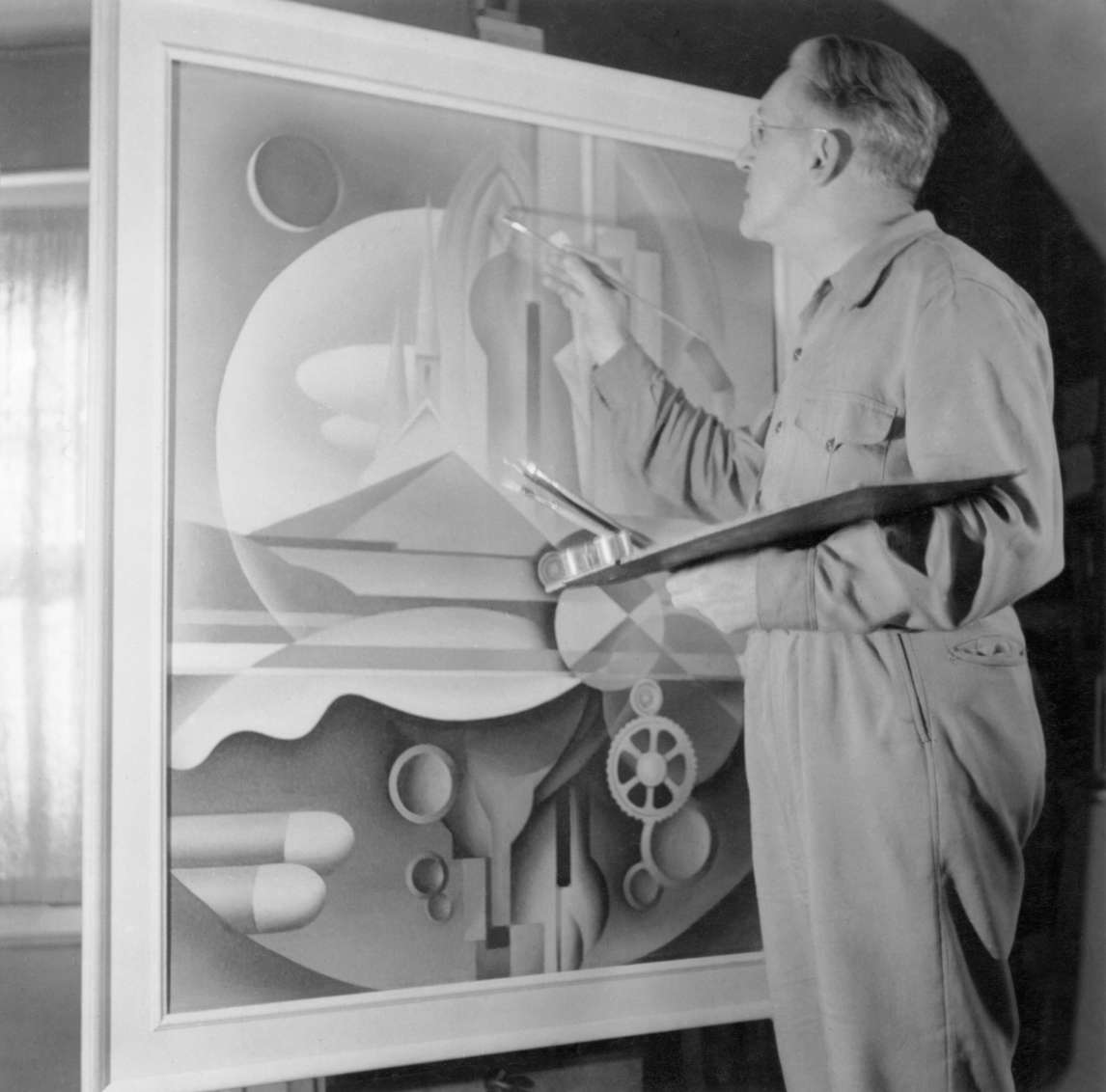 Photograph of Bertram Brooker painting Machine World in his studio, c.1950