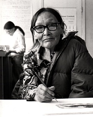 Pitseolak in Lithography Studio signing her work, Cape Dorset, 1976