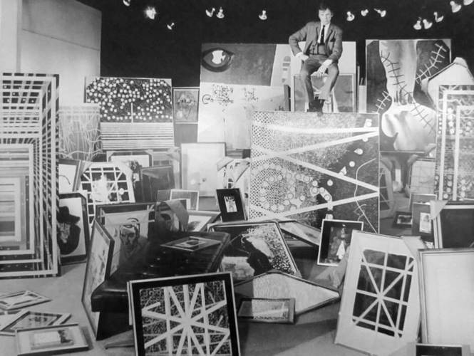 Harold Town with his paintings at the Mazelow Gallery in Toronto in 1967, photographed by John Reeves.